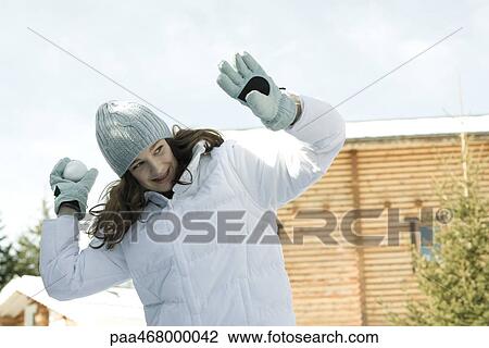 Teen girl throwing snowball View Large Photo Image Stock Image - Teen girl throwing snowball. Fotosearch