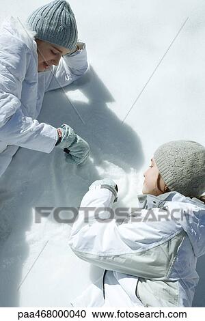 Two teen girls drawing in snow View Large Photo Image Stock Image - Two teen girls drawing in snow. Fotosearch