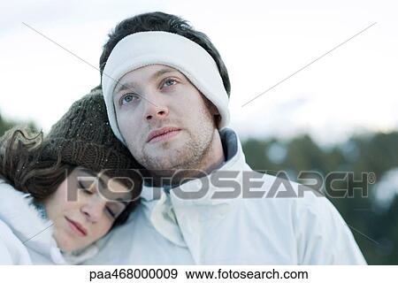 Young couple in snowy landscape, portrait View Large Photo Image Stock Photo - Young couple in snowy landscape, portrait. Fotosearch