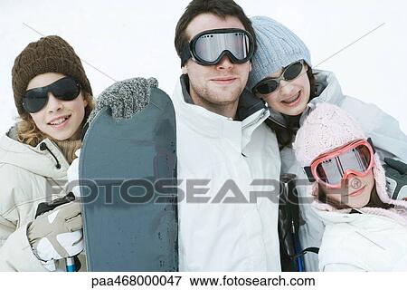 Stock Photo - Young friends dressed in winter sport gear, portrait. Fotosearch