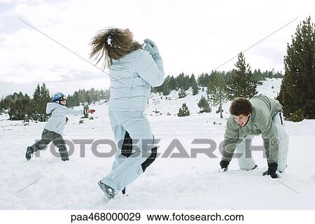 Young friends having snowball fight, action shot View Large Photo Image Stock Photo - Young friends having snowball fight, action shot. Fotosearch