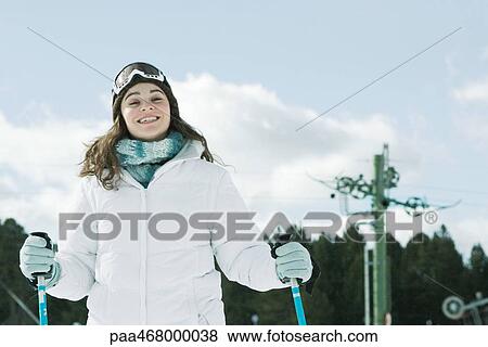 Young woman skiing, smiling at camera, portrait View Large Photo Image Stock Photo - Young woman skiing, smiling at camera, portrait. Fotosearch