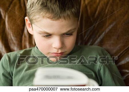 Boy reading, head and shoulders View Large Photo Image Stock Photo - Boy reading, head and shoulders. Fotosearch