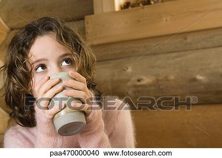 Stock Image - Girl drinking hot drink. Fotosearch