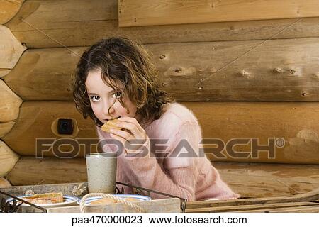 Girl having snack, looking at camera View Large Photo Image Stock Image - Girl having snack, looking at camera. Fotosearch