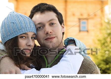 Teen girl and young man hugging, looking at camera, portrait View Large Photo Image Stock Image - Teen girl and young man hugging, looking at camera, portrait. Fotosearch
