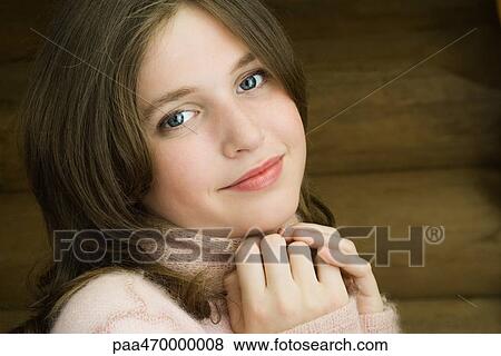 Stock Photo - Teen girl smiling at camera, portrait. Fotosearch