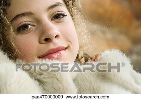 Teen girl under furry blanket, smiling at camera, close-up View Large Photo Image Stock Photo - Teen girl under furry blanket, smiling at camera, close-up. Fotosearch