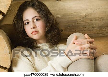 Teen girl with hands clasped around knee, looking at camera View Large Photo Image Stock Photo - Teen girl with hands clasped around knee, looking at camera. Fotosearch
