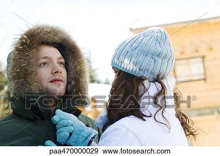 Teen girl zipping up young man's parka, head and shoulders View Large Photo Image Stock Photo - Teen girl zipping up young man's parka, head and shoulders. Fotosearch