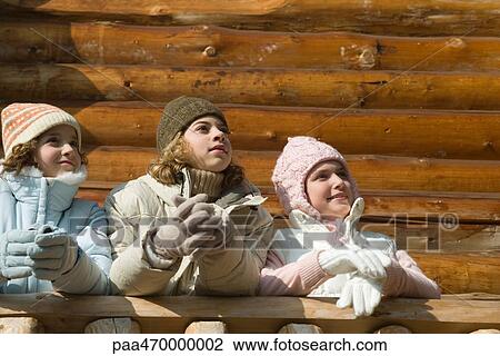 Three preteen or teen girls standing on deck of log cabin, looking away, low angle view View Large Photo Image Stock Image - Three preteen or teen girls standing on deck of log cabin, looking away, low angle view. Fotosearch