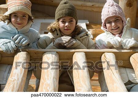 Three preteen or teen girls standing on deck of log cabin, looking down at camera, low angle view View Large Photo Image Stock Image - Three preteen or teen girls standing on deck of log cabin, looking down at camera, low angle view. Fotosearch