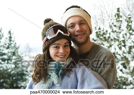 Young couple in winter clothes, smiling at camera, portrait View Large Photo Image Picture - Young couple in winter clothes, smiling at camera, portrait. Fotosearch