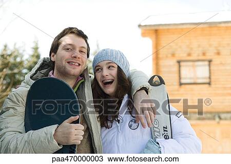 Stock Image - Young skier and snowboarder, smiling, portrait. Fotosearch