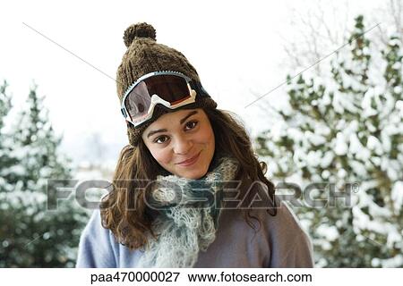 Young woman dressed in ski clothing, smiling at camera, portrait View Large Photo Image Stock Photo - Young woman dressed in ski clothing, smiling at camera, portrait. Fotosearch