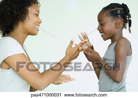 Mother and daughter playing rock paper scissors, side view View Large Photo Image Stock Image - Mother and daughter playing rock paper scissors, side view. Fotosearch