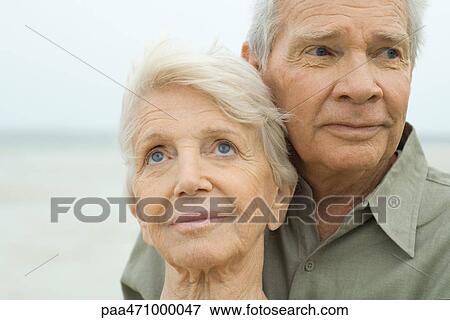 Senior couple outdoors, smiling and looking away, portrait View Large Photo Image Stock Photo - Senior couple outdoors, smiling and looking away, portrait. Fotosearch