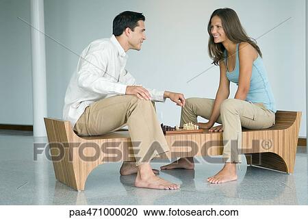 Young couple playing chess, smiling at each other View Large Photo Image Stock Image - Young couple playing chess, smiling at each other. Fotosearch