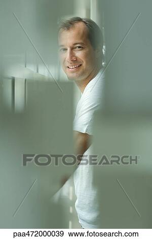 Man smiling over shoulder at camera, selective focus View Large Photo Image Stock Photo - Man smiling over shoulder at camera, selective focus. Fotosearch