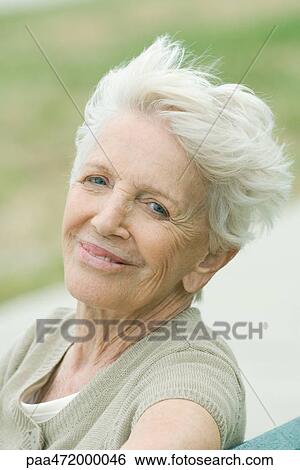 Senior woman smiling at camera, portrait View Large Photo Image Stock Photograph - Senior woman smiling at camera, portrait. Fotosearch