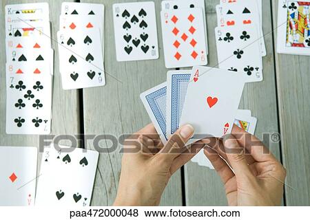 Woman playing card game, cropped view of hands View Large Photo Image Stock Photo - Woman playing card game, cropped view of hands. Fotosearch