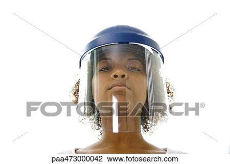 Young woman wearing helmet visor, looking at camera, low angle view View Large Photo Image Stock Image - Young woman wearing helmet visor, looking at camera, low angle view. Fotosearch