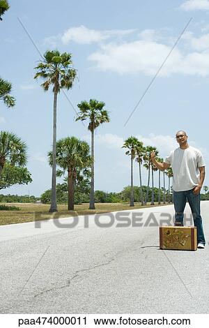 Man hitchhiking, full length View Large Photo Image Stock Image - Man hitchhiking, full length. Fotosearch