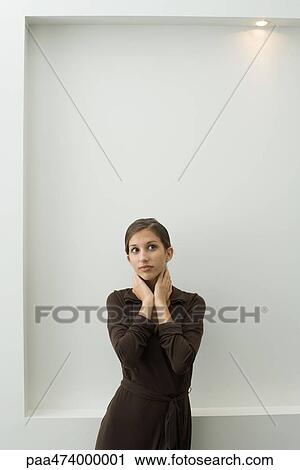 Teenage girl standing with hands on neck, looking away View Large Photo Image Stock Image - Teenage girl standing with hands on neck, looking away. Fotosearch