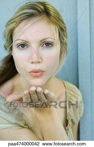 Woman blowing kiss at camera View Large Photo Image Stock Image - Woman blowing kiss at camera. Fotosearch