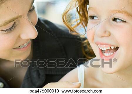 Brother and sister laughing together, cropped view, close-up View Large Photo Image Stock Image - Brother and sister laughing together, cropped view, close-up. Fotosearch