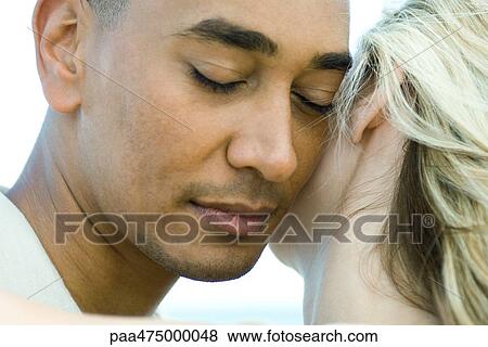 Couple cheek to cheek, man's eyes closed, close-up View Large Photo Image Stock Photo - Couple cheek to cheek, man's eyes closed, close-up. Fotosearch