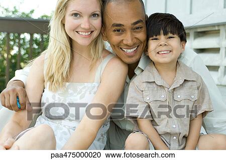 Family smiling at camera together, portrait View Large Photo Image Stock Image - Family smiling at camera together, portrait. Fotosearch