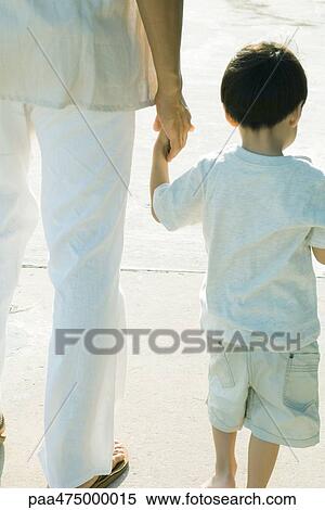 Father and son walking and holding hands, cropped rear view View Large Photo Image Stock Photography - Father and son walking and holding hands, cropped rear view. Fotosearch