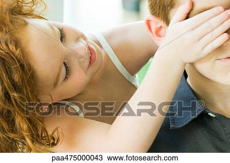 Girl covering her friend's eyes from behind, cropped view View Large Photo Image Stock Image - Girl covering her friend's eyes from behind, cropped view. Fotosearch