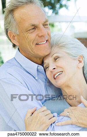 Mature couple embracing and smiling, close-up View Large Photo Image Stock Image - Mature couple embracing and smiling, close-up. Fotosearch