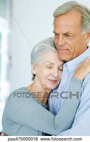 Mature couple embracing, woman's eyes closed, close-up View Large Photo Image Stock Photo - Mature couple embracing, woman's eyes closed, close-up. Fotosearch