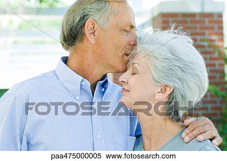 Mature man kissing wife's forehead, side view View Large Photo Image Stock Photography - Mature man kissing wife's forehead, side view. Fotosearch