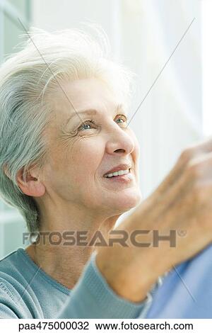Mature woman looking up, smiling, close-up View Large Photo Image Stock Image - Mature woman looking up, smiling, close-up. Fotosearch