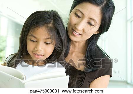 Mother and daughter reading book together, close-up View Large Photo Image Stock Image - Mother and daughter reading book together, close-up. Fotosearch