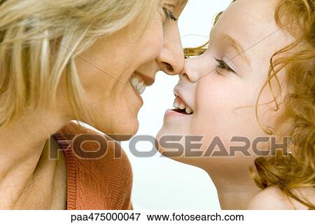 Mother and daughter touching noses and smiling at each other, cropped view View Large Photo Image Stock Photo - Mother and daughter touching noses and smiling at each other, cropped view. Fotosearch