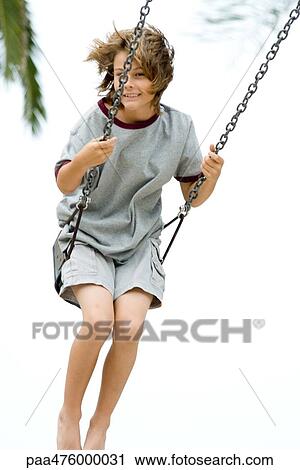 Boy swinging, smiling at camera, full length View Large Photo Image Stock Image - Boy swinging, smiling at camera, full length. Fotosearch