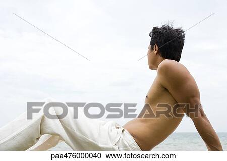 Man sitting and looking at view, side view View Large Photo Image Stock Image - Man sitting and looking at view, side view. Fotosearch