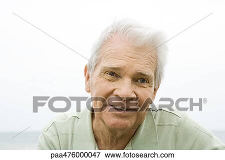 Stock Photo - Senior man smiling outdoors, portrait. Fotosearch