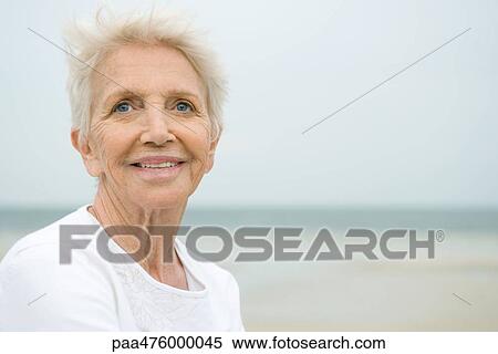 Senior woman smiling, looking away, portrait View Large Photo Image Stock Photography - Senior woman smiling, looking away, portrait. Fotosearch