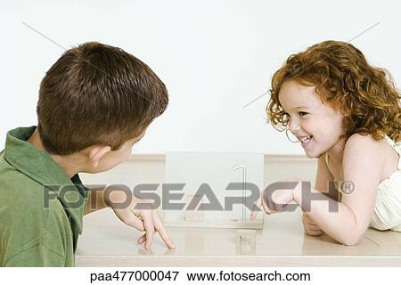 Stock Photo - Boy and little sister playing. Fotosearch