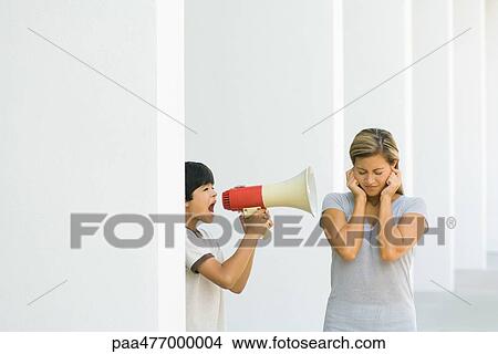 Boy screaming at mother through megaphone View Large Photo Image Picture - Boy screaming at mother through megaphone. Fotosearch