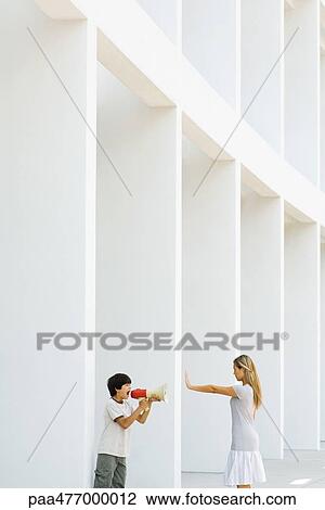Boy screaming with megaphone, woman holding out hand View Large Photo Image Stock Image - Boy screaming with megaphone, woman holding out hand. Fotosearch