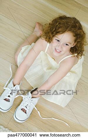 Little girl on floor with hands in shoes, smiling, view from directly above View Large Photo Image Stock Image - Little girl on floor with hands in shoes, smiling, view from directly above. Fotosearch