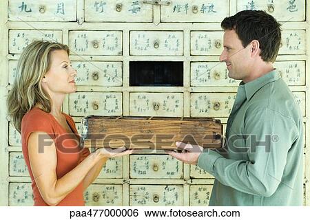 Man and woman holding drawer between them, side view, waist up View Large Photo Image Stock Photograph - Man and woman holding drawer between them, side view, waist up. Fotosearch
