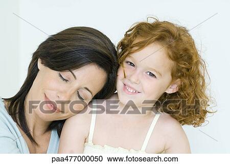 Mother and daughter, woman resting head on girl's shoulder, girl smiling at camera View Large Photo Image Stock Image - Mother and daughter, woman resting head on girl's shoulder, girl smiling at camera. Fotosearch